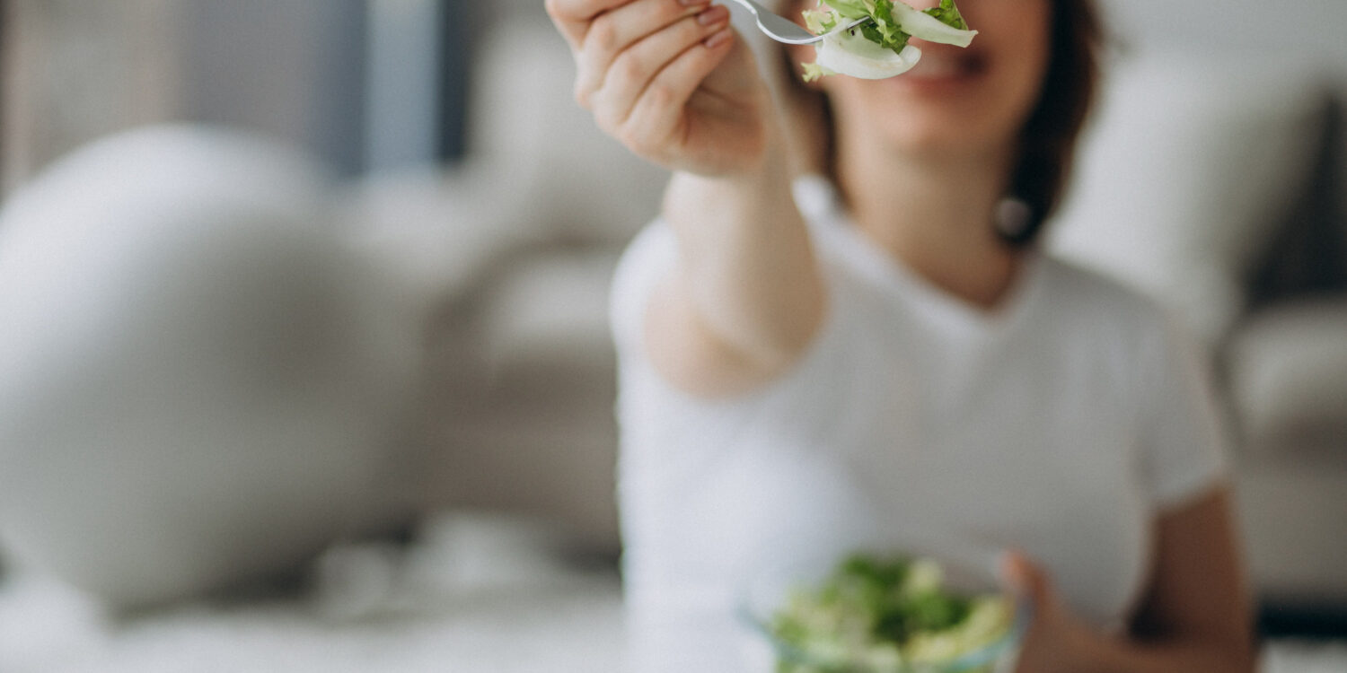 young-pregnant-woman-eating-salad-home